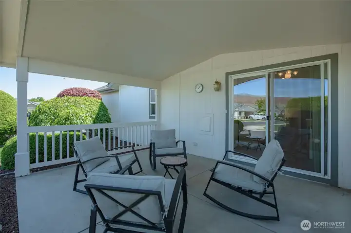 This upscale wood-framed covered patio provides ample sheltered space for outdoor cooking, entertaining, or maybe just lounging in hammocks!