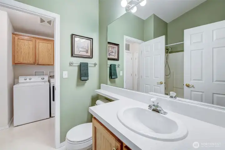 Full-size main bathroom can be accessed from both the hallway and the utility room