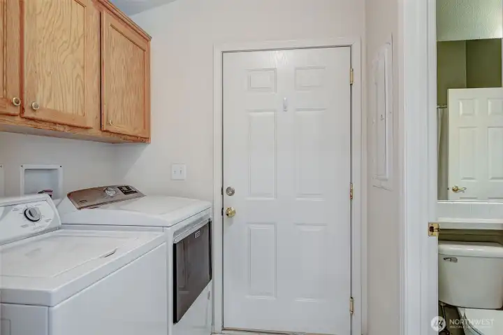 Utility room has a new Maytag dryer, storage cabinets, access to main bathroom, access to the furnace (not shown) and broom/coat closet (not shown).