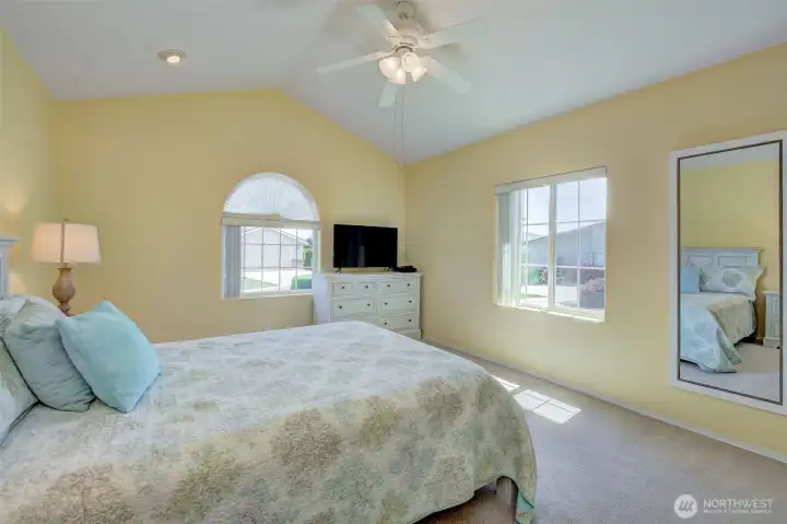 Warm, inviting Primary bedroom offers space for every piece of furniture you have...