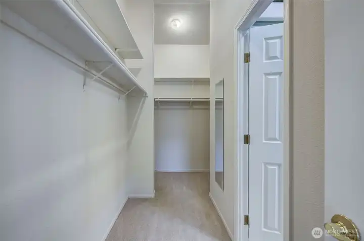 In addition to the size of this primary closet, it also offers extra functionality w/doors from both the bedroom and the bathroom