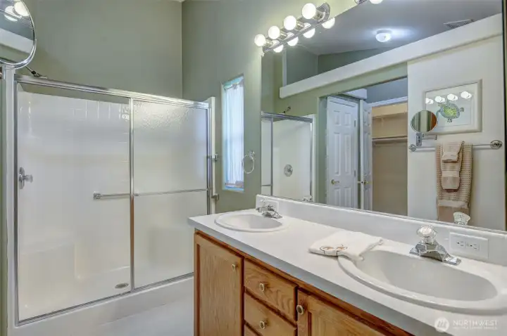 Spacious primary ensuite bathroom offers oversized walk-in shower and dual vanity