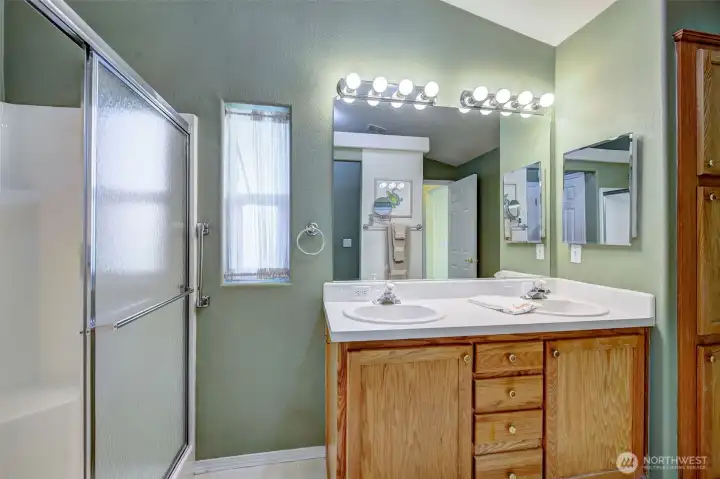 Spacious primary ensuite bath also provides a large linen closet (partially shown on right)