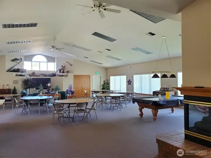 Inside the gathering hall of the clubhouse! Billiards and a cozy gas fireplace on the right.