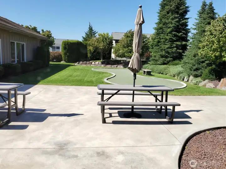 Community space outside the clubhouse with tables, BBQ and putting green. Plus lots of parking for guests!