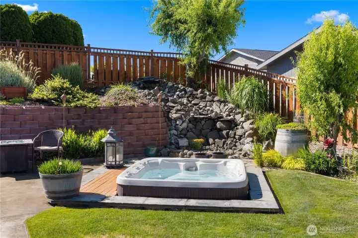 Back yard hot tub with relaxing waterfall Back yard hot tub with relaxing waterfall
