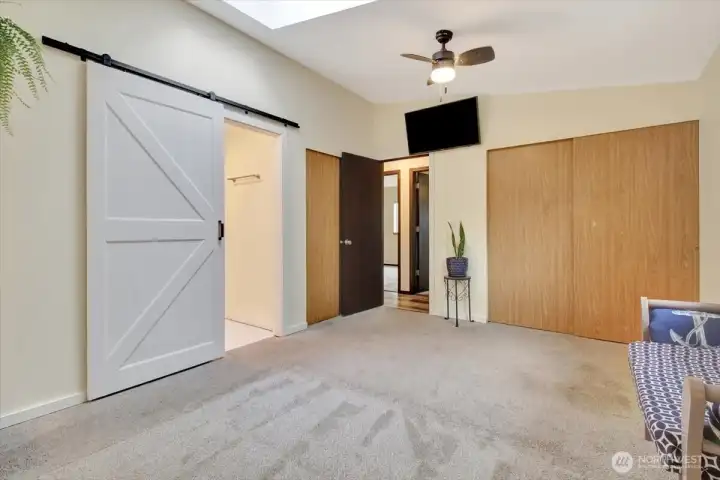 Primary bedroom--barn door leads to en-suite bathroom. Primary bedroom--barn door leads to en-suite bathroom.