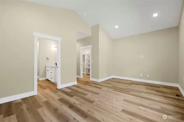 This angle shows the primary suite with a look at the luxurious bath and the spacious walk-in closet.  Check out the gorgeous trim package that is throughout this home.