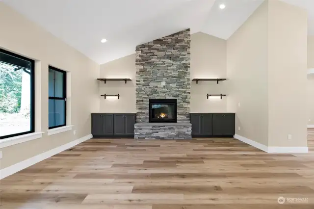 Gorgeous stone, propane gas fireplace with beautiful built ins