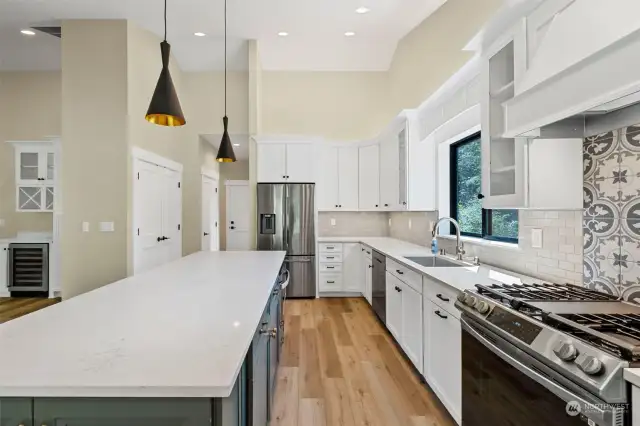 This angle shows the large pantry in the kitchen with lots of soft close cabinetry, gas cooktop, drawer style microwave, stainless appliances.  Cook anyone????
