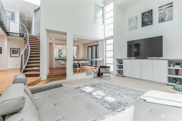 View from family room highlight 20 ft ceilings and floating metal staircase.