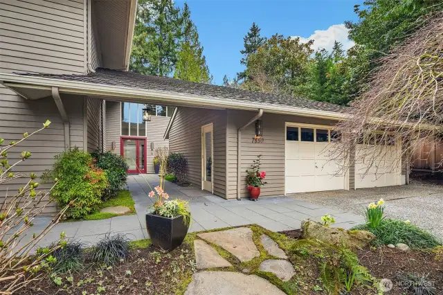 Spacious covered breezeway from 2-car garage to home.
