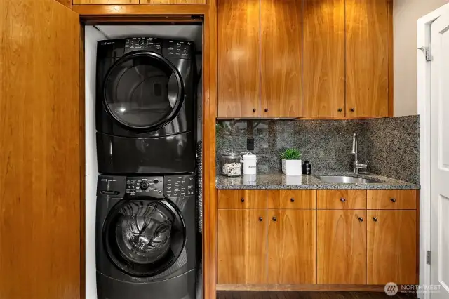 Wet bar with granite surfaces + concealed laundry area and special hanging bar for clothes drying.