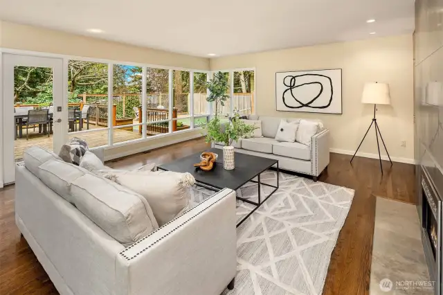 The light-filled living room opens to the back deck for easy indoor/outdoor entertaining.