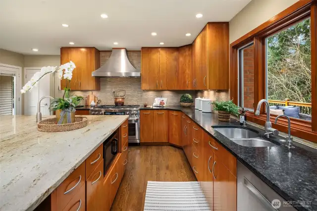 Ample custom soft-close cherry cabinets feature roll-out drawers + a pull-out spice cabinet.