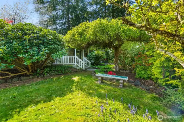 Tranquil meditation space in the front yard with steps to front porch in the background