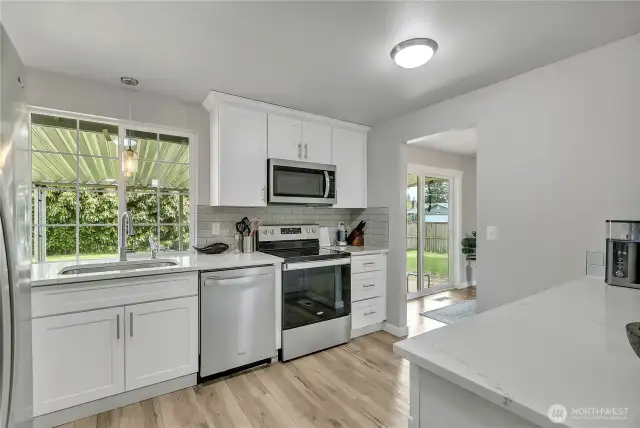 Cheerful kitchen overlooks backyard and lush greenery