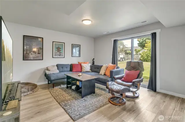 Lower level Bonus Room with slider access to large and fully fenced backyard