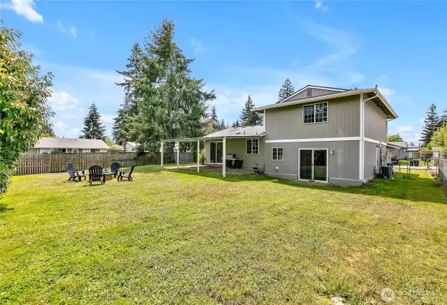 Wonderful backyard features covered patio and firepit or gathering area