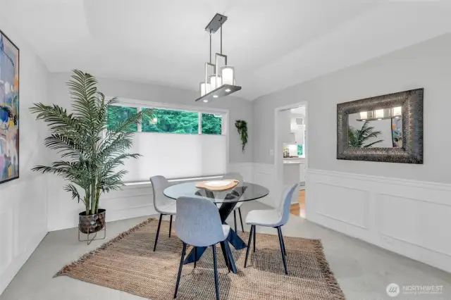 The formal dining room showcases elegant shadow boxing on the walls, adding depth and architectural interest.