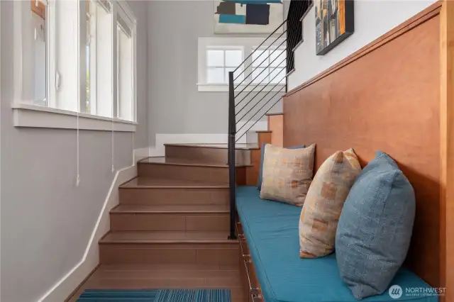 The finely crafted stairwell features custom welded steel railings.