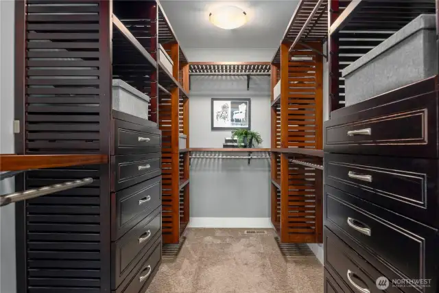 The large walk-in closet features custom storage and organizers.