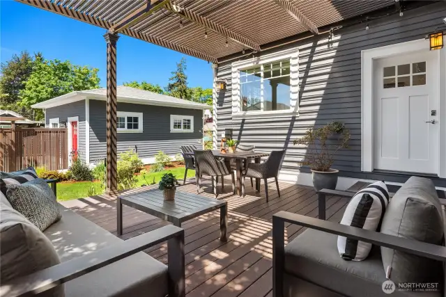 Looking over the manicured backyard with the electronic louvered patio cover open for sunlight. Close it for a fully covered dry patio.