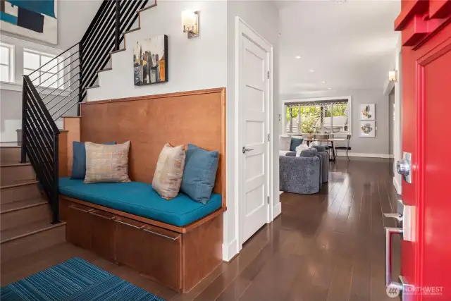 The formal entry features a soaring vaulted ceiling and built-in bench with storage underneath.