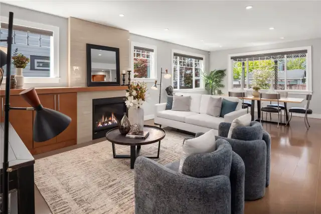 A gas fireplace with built-in cabinet and wood mantle provides an added warmth to the forced air heating.