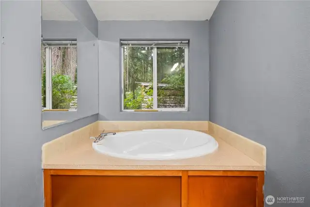 Soaker tub with a window perfect for relaxation.