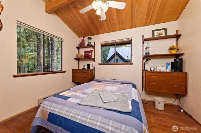 Wide planked flooring continued in the bedroom keeping the PNW ambiance.
