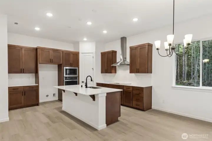 ***Actual Home *** Kitchen dining area with Ginger stained cabinets and bronze fixtures