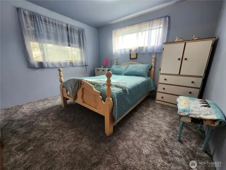 Bedroom with 2 windows making a light bright room