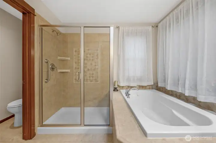 The primary bath features a luxurious soaking tub, and dual sinks and separate shower..
