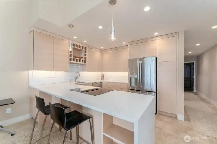 Kitchen updated with eating space for 2-3 bar stools (bar stools stay with the sale), plenty of storage spaces in the kitchen area with pantry room.  All new appliances, countertops with waterfall effect, clean colors and lines.