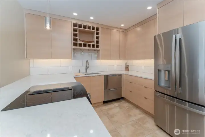 Another view of the kitchen with tile floors and refrigerator with ice and water both.