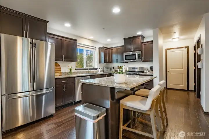 Granite countertops & stainless steel appliances complete this kitchen! Island-seating, a bonus!