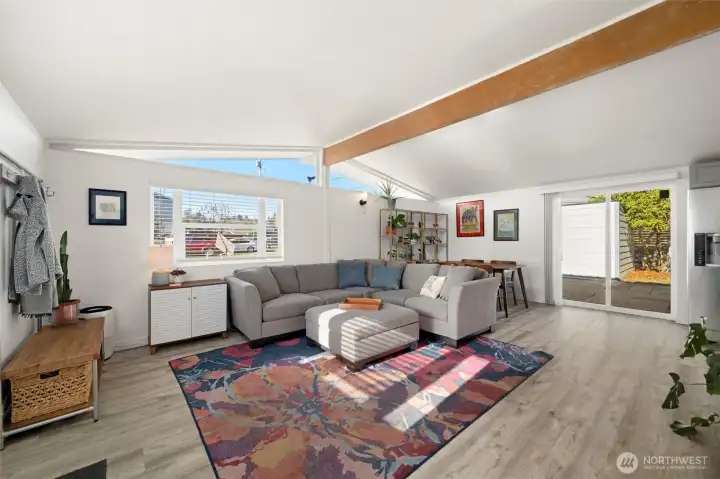Sun soaked living room with vaulted ceilings, exposed beam and mid-century modern clerestory windows.