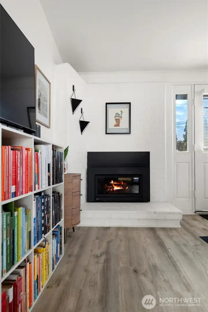 Original brick fireplace has been modernized with a newer gas insert.