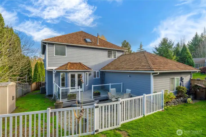 Trex deck steps down to a gated paver patio, thoughtfully separated from the koi pond and garden oasis.