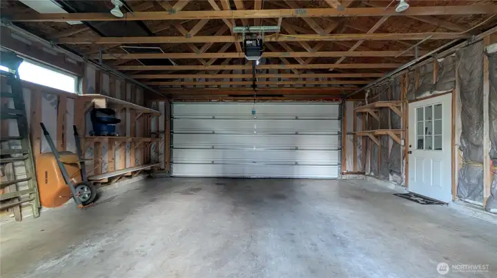 Incredible full-sized two-car garage space with electric car charging station already installed! (And the third parking space walled, insulated, and heated to the right)