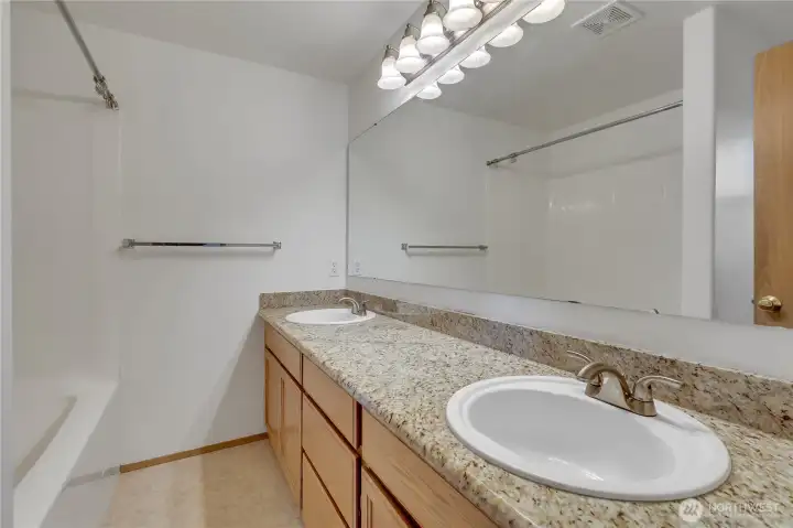 Primary bath has 2 sinks, and newer granite counters, sinks and faucets