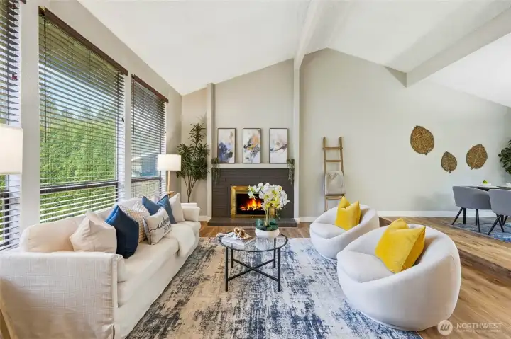 Vaulted ceilings and abundant natural light greet you in the formal living room with cozy fireplace.