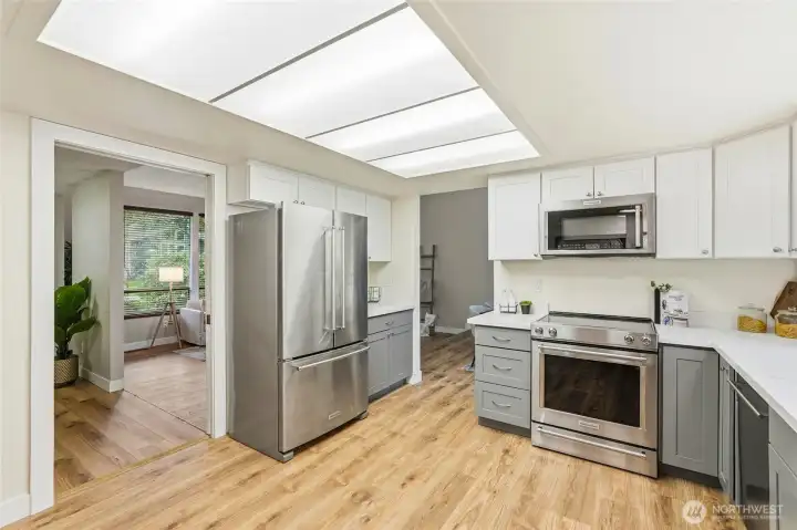 Newer refrigerator, range, microwave with hood, and dishwasher.