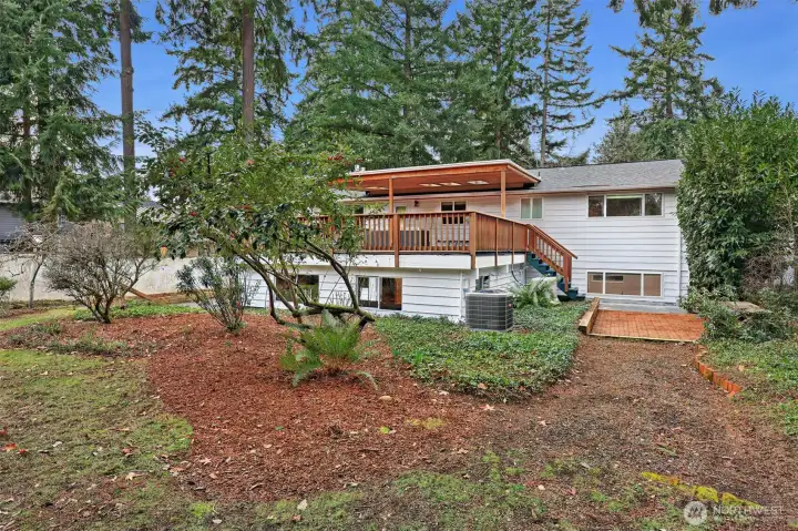 Looking toward the back patio with stairs leading up to the covered deck.