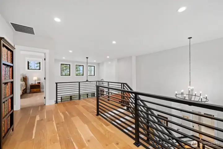 Custom railing, engineered hardwood floors, and flooded with light!