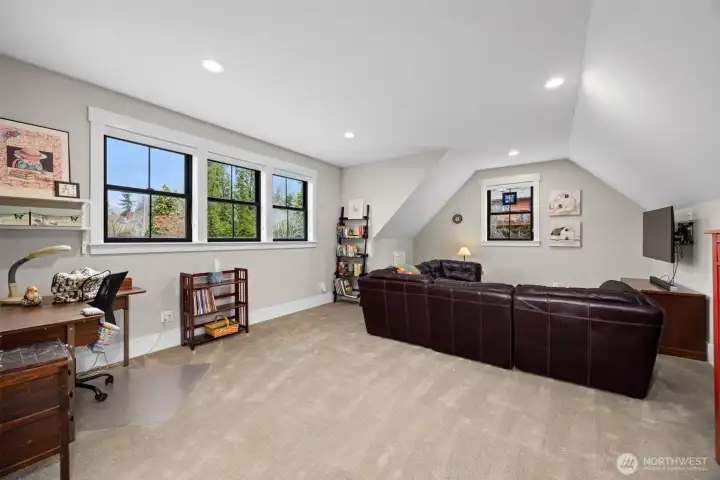 Large rec room over the garage offers flexible space for a media room, playroom, or home gym.