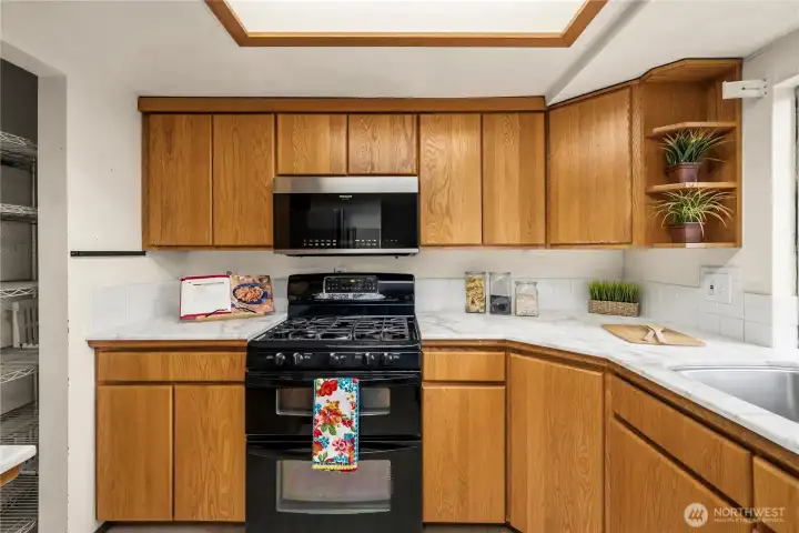 Closer view of the oven and cabinets.