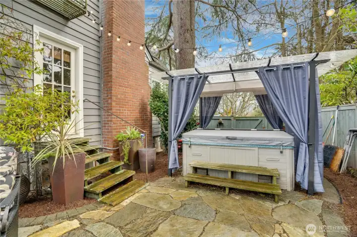 A private side yard retreat with a hot tub just steps from the living room—perfect for unwinding. The chimney was rebuilt from the roofline up in 2023 for added peace of mind.