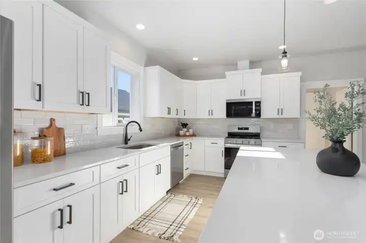 Beautiful quartz counter tops and tiled backsplash.